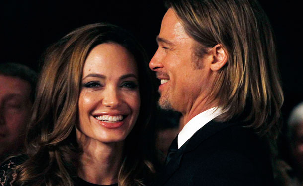 Actress Angelina Jolie smiles with her partner Brad Pitt as they arrive at the 23rd annual Producers Guild Awards in Beverly Hills, California, January 21, 2012. Jolie, who directed and produced the film "In The Land of Blood and Honey", and other producers of the film received the Stanley Kramer Award at the event. (REUTERS)