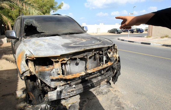 A resident to a car which was intentionally burnt by young thugs who threw bottle filled with petrol at a residential area in Al Qouz in Dubai. (Patrick Castillo)