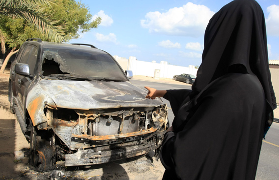 A resident to a car which was intentionally burnt by young thugs who threw bottle filled with petrol at a residential area in Al Qouz in Dubai. (Patrick Castillo)