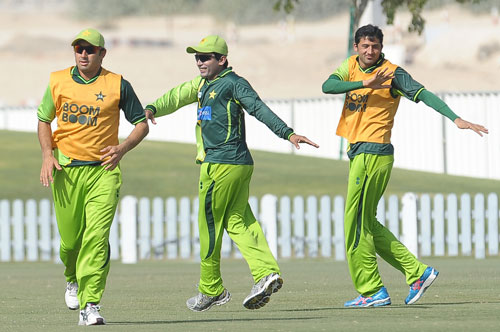 Pakistan's cricketers Saeed Ajmal (left), Adnan Akmal (centre) and Junaid Khan warm up during a practice session at the ICC Global Cricket Academy at Dubai Sports City on February 1, 2012 (AFP)