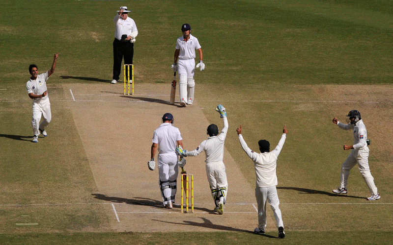Pakistan's Abdur Rehman (L) celebrates the dismissal of England's Andrew Strauss (3rd L) during the third test cricket match at Dubai International cricket stadium in Dubai February 6, 2012. REUTERS