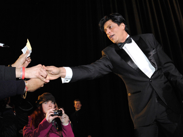 Cast member Shah Rukh Khan shakes hands with fans after the screening of the movie "Don - The King is back" at the 62nd Berlinale International Film Festival in Berlin February 11, 2012.  (REUTERS)