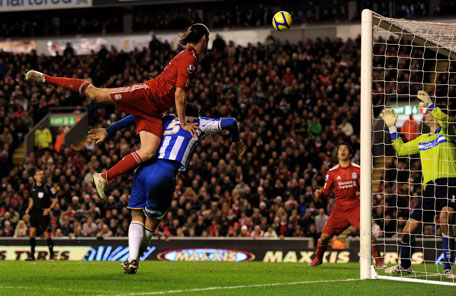 Andy Carroll of Liverpool provides an assist for Luis Suarez to score his team's sixth goal during the FA Cup fifth round match against Brighton & Hove Albion at Anfield on Sunday in Liverpool, England. (GETTY)