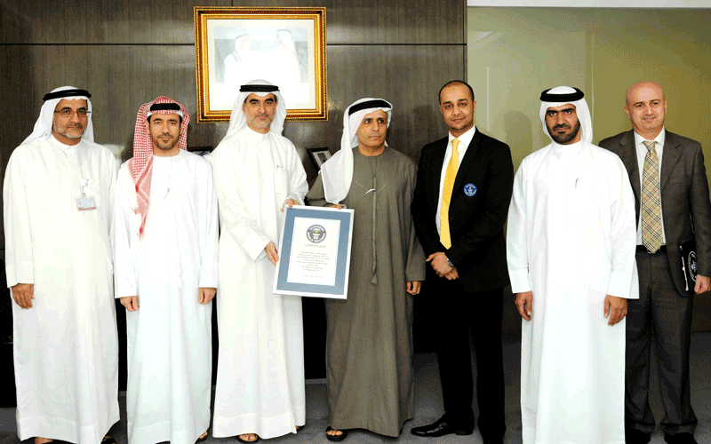Al Tayer receiving the Guinness certificate from Talal Omar (SUPPLIED)