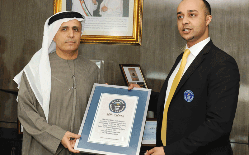 Al Tayer receiving the Guinness certificate from Talal Omar (SUPPLIED)