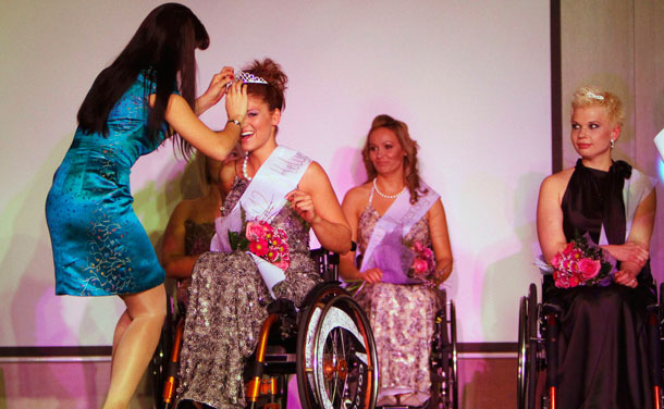 Fashion model Szilvia Magony places the crown onto Katalin Eszter Varga for winning the Miss Colours Hungary, the country's first wheelchair beauty contest, in Budapest February 25, 2012. (REUTERS)