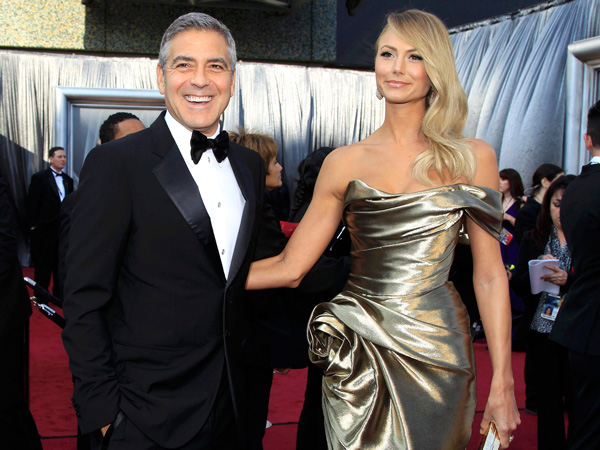George Clooney, best actor nominee for his role in "The Descendants," and his girlfriend, Stacy Keibler pose on the red carpet as they arrive at the 84th Academy Awards in Hollywood, California, February 26, 2012.  (REUTERS)