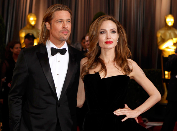 Actor Brad Pitt poses with partner, actress Angelina Jolie on the red carpet at the 84th Academy Awards in Hollywood, California, February 26, 2012.   (REUTERS)