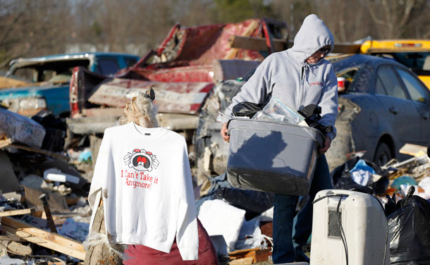 A sweatshirt proclaiming "I can't take it anymore" hangs amid the debris of homes where several people died in tornado destruction in East Bernstadt, Kentucky March 3, 2012. (REUTERS)