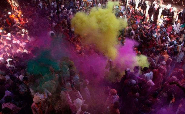 People throw coloured powder as they celebrate "Lathmar Holi" at Barsana in the northern Indian state of Uttar Pradesh. Holi, also known as the Festival of Colours, heralds the beginning of spring and is celebrated all over India. (REUTERS)
