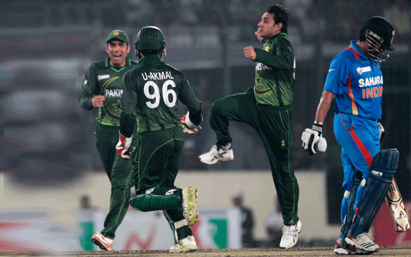 India's Sachin Tendulkar (right) leaves the field as Pakistan's Saeed Ajmal (centre) celebrates his dismissal with teammates during their Asia Cup One Day International match in Dhaka. (REUTERS)