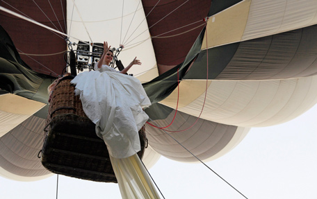 Emma, a 17 year-old model, waves from a hot air balloon as she wears the wedding dress with the longest train in the world during a Guinness World Record attempt in Bucharest. The 2,750 meter long train broke a previous record of 2,488 meters. It is made of 4,700 meters of material using 1,857 needles, taking 100 days to made. (REUTERS)