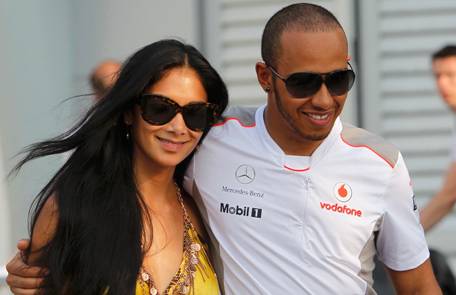 McLaren Formula One driver Lewis Hamilton of Britain walks with his girlfriend Nicole Scherzinger after the qualifying session of the Malaysian F1 Grand Prix at Sepang International Circuit outside Kuala Lumpur. (REUTERS)
