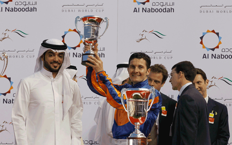Colm O'Donoghue, riding Daddy Long Legs of the U.S., accepts the trophy after winning the fourth race during the 17th Dubai World Cup at the Meydan racecourse in Dubai. The Dubai World Cup, with a cash prize of $10 million, is horse racing's richest race. (REUTERS)