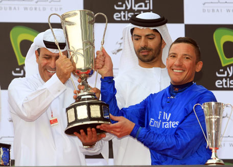 Godolphin jockey Frankie Dettori and trainer Saeed bin Suroor being presented with the trophy after winning the Godolphin Mile sponsored by Etisalat during the Dubai World Cup at Meydan on Saturday. (PATRICK CASTILLO)