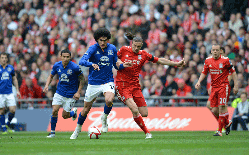 Liverpool's English striker Andy Carroll (R) vies with Everton's Belgian midfielder Marouane Fellaini (L) during the FA Cup semi-final football match between Everton and Liverpool at Wembley Stadium in London, England. (AFP)