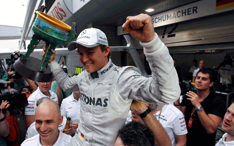 Mercedes Formula One driver Nico Rosberg of Germany celebrates with crew members winning the Chinese F1 Grand Prix at Shanghai International circuit. Rosberg won the Chinese Grand Prix for Mercedes from pole position on Sunday in the first victory of his 111-race Formula One career. (REUTERS)