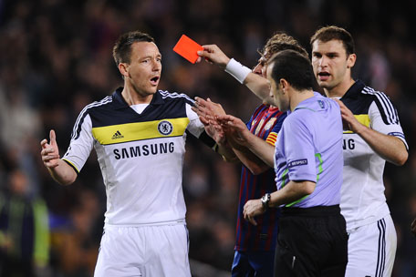 Chelsea's John Terry (left) is shown a red card by referee Cuneyt Cakir during the UEFA Champions League semifinal, second leg against FC Barcelona at Camp Nou on Tuesday in Barcelona, Spain. (GETTY)