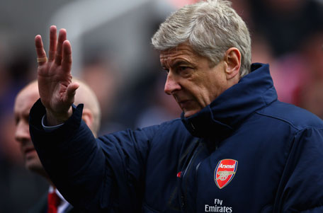 Arsenal manager Arsene Wenger waves at the crowd during a Barclays Premier League match. (GETTY)