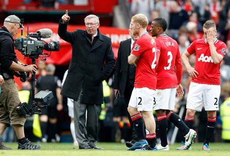 Manchester United's manager Alex Ferguson sends his team to thank the crowd after their English Premier League match against Swansea City at Old Trafford in Manchester, England, on Sunday. (REUTERS)