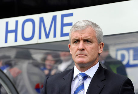 Queens Park Ranger's manager Mark Hughes looks out from the dug out at the start of their English Premier League match against Stoke City at Loftus Road in London on Sunday. (REUTERS)