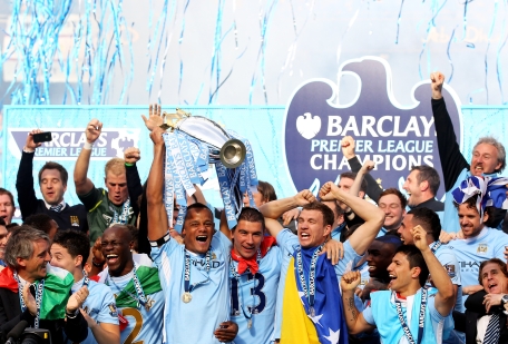 Manchester City captain Vincent Kompany lifts the trophy following the Barclays Premier League match against Queens Park Rangers at the Etihad Stadium on Sunday in Manchester, England. (GETTY)