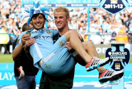 Teammates David Silva and Joe Hart of Manchester City celebrate following the Barclays Premier League match against Queens Park Rangers at the Etihad Stadium on Sunday in Manchester, England. (GETTY)