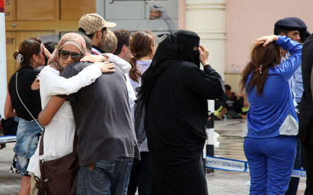 Relatives of children stuck inside Doha's Villaggio Mall cry as they wait for news after a fire broke out inside the Gulf emirate's upscale shopping centre on May 28, 2012, killing at least 19 people, including 13 children, and two members of the civil defence. The fire started at a nursery, state minister for the interior Abdullah bin Nasser Al-Thani told reporters, adding that firefighters had to break through the roof to get to trapped children after a staircase to the first-floor nursery collapsed. (AFP)