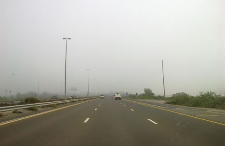 The Burj Khalifa hidden in the fog along Al Ain Highway coming into Dubai (ED)