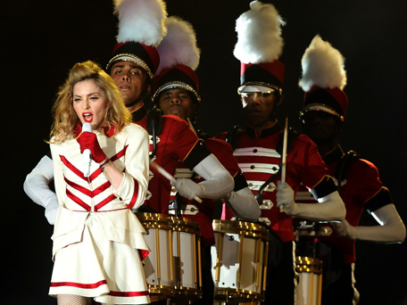 US pop icon Madonna (front) performs on stage during her first ever concert in the Gulf as part of her MDNA world tour at Abu Dhabi's Yas Island Stadium on June 3, 2012. An estimated 25,000 fans cheered and screamed as the Material Girl finally appeared on stage more than two hours late, wearing a skin-tight black outfit from her "Girl Gone Wild" album. (AFP)