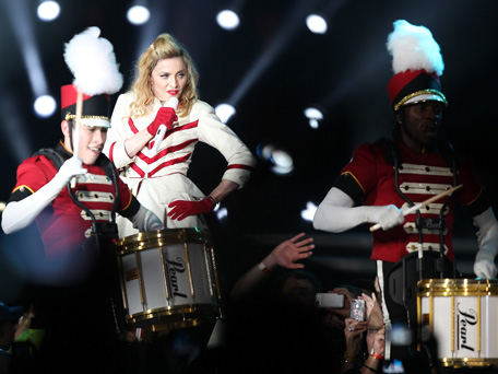 US pop icon Madonna (2L) performs on stage during her first ever concert in the Gulf as part of her MDNA world tour at Abu Dhabi's Yas Island Stadium on June 3, 2012. An estimated 25,000 fans cheered and screamed as the Material Girl finally appeared on stage more than two hours late, wearing a skin-tight black outfit from her "Girl Gone Wild" album. (AFP)