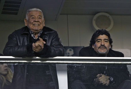 Argentine great and Al Wasl team coach Diego Maradona (right) and his father 'Don Diego' wait for the start of the match between Boca Juniors and Arsenal at 'La Bombonera' stadium in Buenos Aires, Argentina, on Sunday. (AFP)