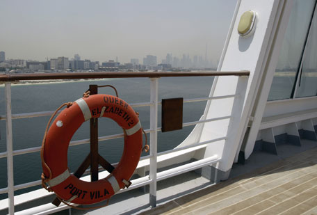 The skyline of Dubai is seen from the rear deck of the Queen Elizabeth 2 as Istithmar World, the Dubai state investment company that owns the ship, outlined plans Monday to turn the retired cruise liner into a 300-room hotel in Port Rashid, Dubai, United Arab Emirates. Britain's Queen Elizabeth II launched the QE2 in 1967. (AP)