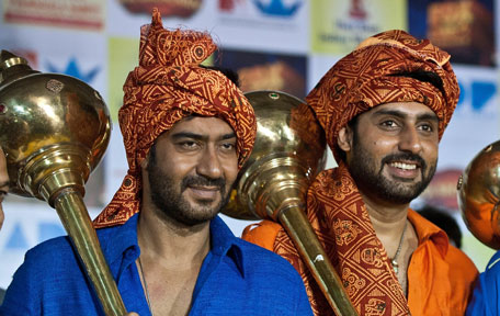 Indian Bollywood actors Ajay Devgan (L) and Abhishek Bachchan pose during a promotion for the Hindi film "Bol Bachchan" in New Delhi. (AFP)