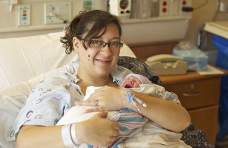 Katie Medley holds her newborn son Hugo Jackson Medley at the hospital in Aurora, Colo, Tuesday, July 24, 2012. (AP)