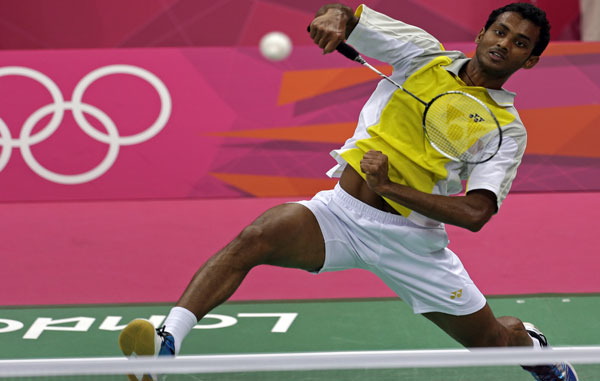 Sri Lanka's Niluka Karunaratne returns the shuttlecock to Japan's Kenichi Tago during a men's singles badminton match at the 2012 Summer Olympics, Monday, July 30, 2012, in London. (AP)