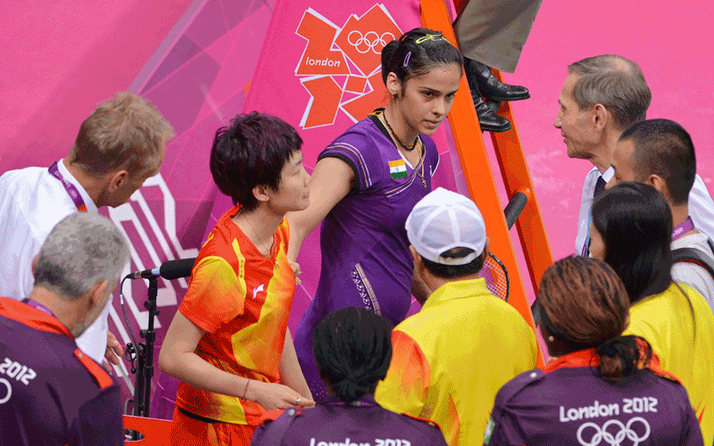 India's Saina Nehwal (Top C) comforts China's Wang Xin after Wang sustained an injury in their bronze medal women's singles badminton match at the London 2012 Olympic Games in London. (AFP)