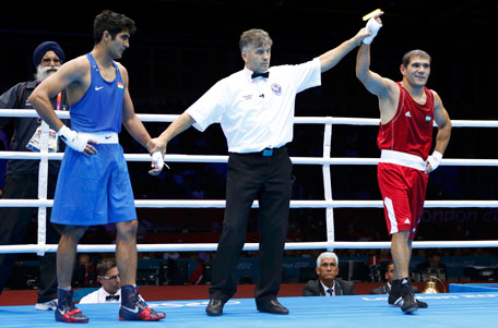 Uzbekistan's Abbos Atoev (right) is declared the winner over India's Vijender Singh during their Men's Middle (75kg) quarter-final at the London Olympic Games on Monday. (REUTERS)