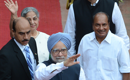 Indian Prime Minister Manmohan Singh (C) waves after delivering his speech as Indian Defence Minister AK Antony (R) watches on India's 66th Independence Day in New Delhi on August 15, 2012. Manmohan Singh used his Independence Day speech to promise to improve conditions for foreign investment in the country after a sharp downturn in economic growth. (AFP)