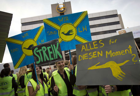 Cabin staff of German airline Lufthansa hold up posters as they strike on August 31, 2012 at the airport in Frankfurt/M., western Germany. Lufthansa has been forced to cancel "a large part" of its 360 scheduled flights in and out of Frankfurt on Friday morning owing to walkouts by cabin staff, the company said. Primarily affected were domestic and European flights, but a small number of long-haul services was also being hit by knock-on effects. Cabin staff are staging the strike in their fight for higher pay. (AFP)