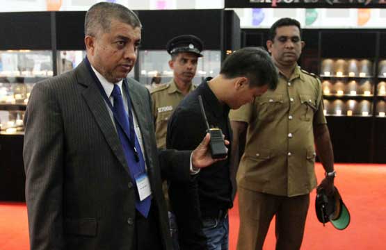 A Sri Lankan security official and uniformed police escort a Chinese national who is accused of stealing a $13,800 diamond by swallowing it while pretending to appraise the stone at Sri Lanka's main gem and jewellery exhibition in Colombo on September 5, 2012. The 32-year-old Chinese man had asked the stall owner for a close inspection of the diamond, before swallowing it, on the opening day of Facets Sri Lanka, an annual exhibition in Colombo (AFP)