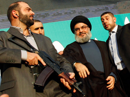 Lebanon's Hezbollah leader Sayyed Hassan Nasrallah (2nd R), escorted by his bodyguards, greets his supporters at an anti-U.S. protest in Beirut's southern suburbs September 17, 2012. Nasrallah made a rare public appearance on Monday to address tens of thousands of marchers protesting against a film made in the United States that mocks the Prophet Mohammad. Nasrallah has been living in hiding to avoid assassination since Hezbollah fought a month-long war with Israel in 2006. (REUTERS)