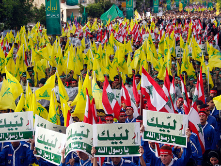 Lebanon's Hezbollah al-Mahdi scouts shout slogans and carry banners and Hezbollah and Lebanese flags as they march at an anti-U.S. protest in Beirut's southern suburbs September 17, 2012. Lebanon's Hezbollah leader Sayyed Hassan Nasrallah made a rare public appearance on Monday to address tens of thousands of marchers protesting against a film made in the United States that mocks the Prophet Mohammad. Nasrallah has been living in hiding to avoid assassination since Hezbollah fought a month-long war with Israel in 2006. The Arabic on the headscarves and banners read, "In your name prophet of God".  (REUTERS)