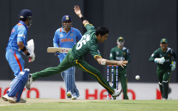 Pakistan's bowler Umar Gul, center, runs to stop the ball after a shot played by India's batsman Virender Sehwag, second left, during their warm-up match ahead of the ICC Twenty20 Cricket World Cup in Colombo, Sri Lanka, Monday, Sept. 17, 2012. The tournament starts Sept. 18. (AP)