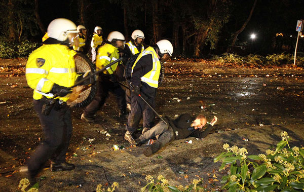 Riot police officers stand next to a man lying on the ground as they went into action in the northern Dutch town of Haren late on September 21, 2012 to contain thousands of party-goers who turned up after a teenager's birthday invite on Facebook went viral. The police had been on high alert after the schoolgirl posted a message inviting friends to her 16th birthday party, but forgot to mark it as a private event, prompting more than 20,000 replies.
Public television station NOS said up to 4,000 people, the vast majority of them young, had turned up in Haren, population 18,000. (AFP)