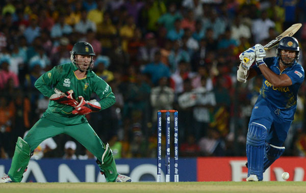 Sri Lanka cricketer Kumar Sangakkara (R) plays a shot as South African wicketkeeper AB de Villiers (L) looks on during the ICC Twenty20 Cricket World Cup match between South Africa and Sri Lanka at The Mahinda Rajapaksa International Cricket Stadium in Hambantota on September 22, 2012.  (AFP)