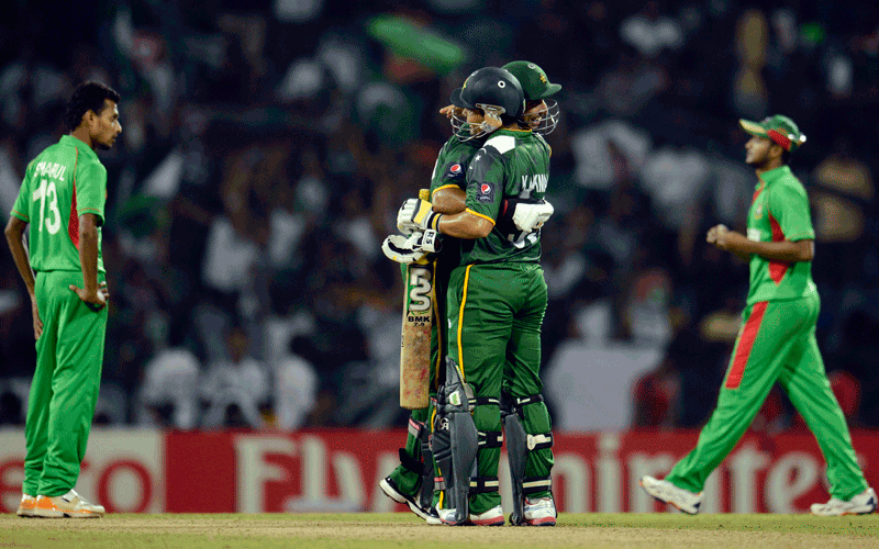 Pakistan's Imran Nazir and Kamran Akmal embrace after the defeat of Bangladesh in their Twenty20 World Cup group D match at Pallekele. (REUTERS)