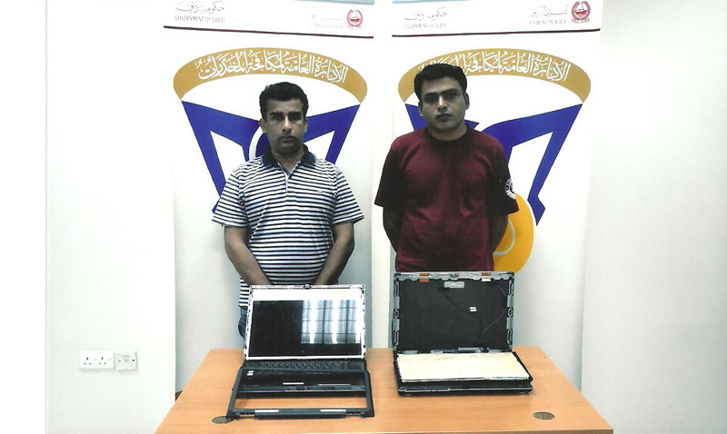 The two drug smugglers with the laptops in which the heroin was concealed.