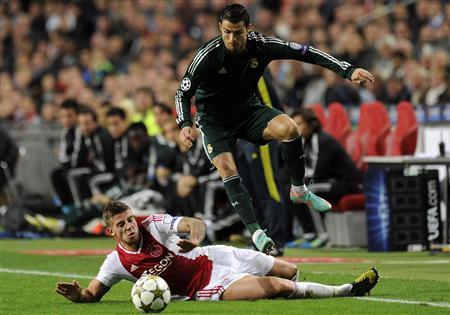 Ajax Amsterdam's Toby Alderweireld (bottom) fights for the ball with Real Madrid's Cristiano Ronaldo during their Champions League Group D soccer match at the Amsterdam Arena stadium October 3, 2012. (REUTERS)