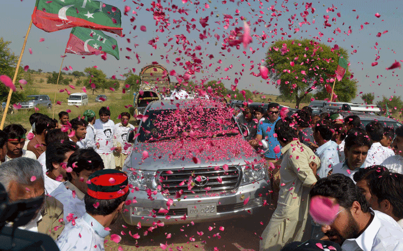 Pakistan people welcome the convoy of cricket star turned politician Imran Khan on his rally towards the tribal areas, in Mianwali. Pakistan cricket star turned politician Imran Khan led Western peace activists and local loyalists on a highly publicised rally to Pakistan's tribal belt Saturday in protest against US drone strikes. (AFP)